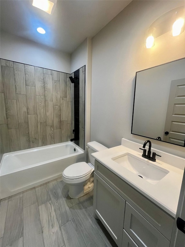 full bathroom with toilet, vanity, and tiled shower / bath