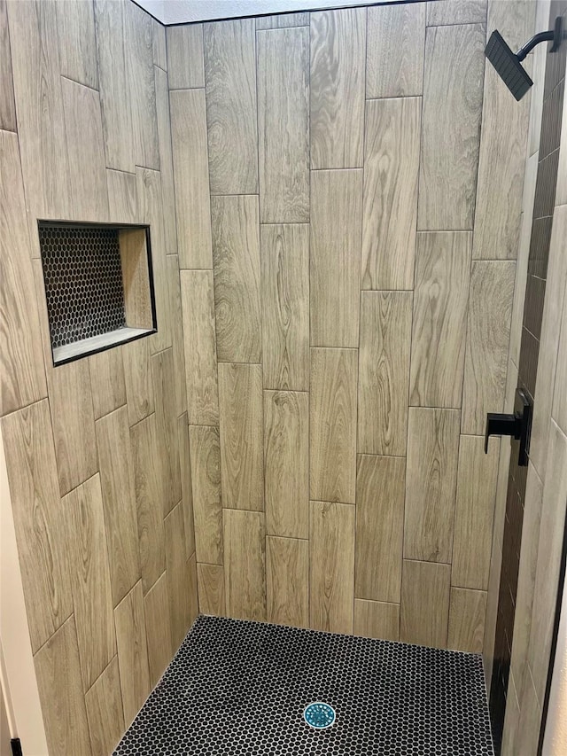 bathroom with a tile shower