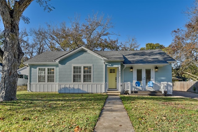 view of front of home featuring a front yard and french doors