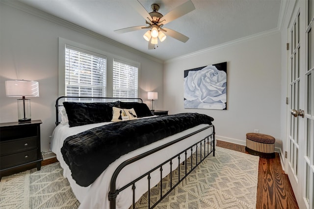 bedroom featuring ceiling fan, crown molding, and light hardwood / wood-style flooring