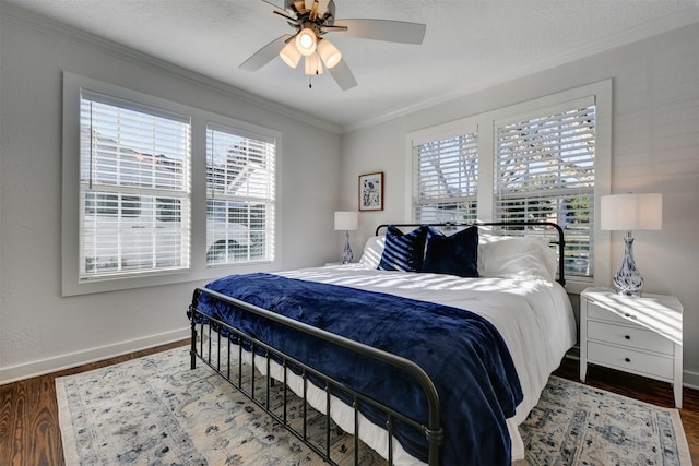 bedroom with ceiling fan, hardwood / wood-style floors, crown molding, and a textured ceiling