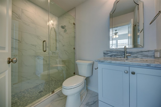 bathroom featuring vanity, toilet, and a shower with door