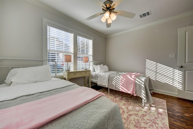 bedroom featuring ceiling fan, dark hardwood / wood-style floors, and ornamental molding