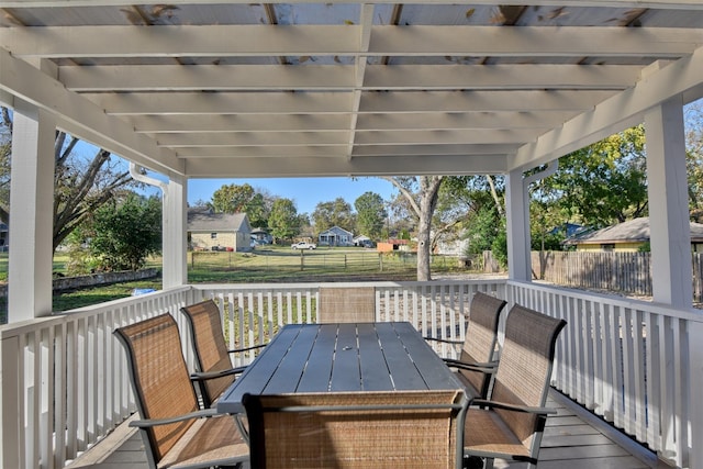 wooden deck with outdoor dining area, a fenced backyard, and a residential view