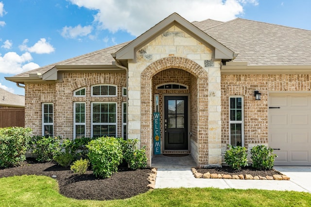 view of exterior entry with a garage