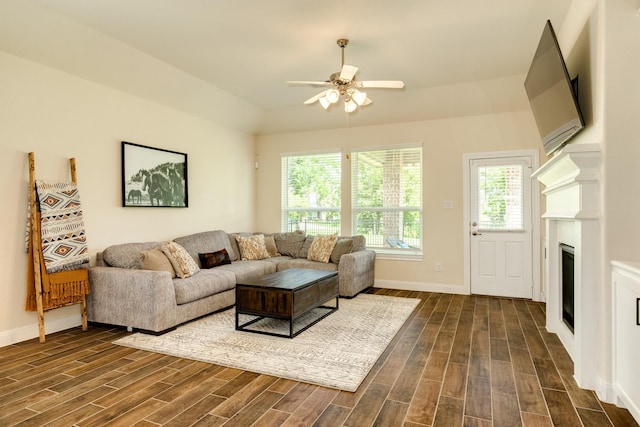 living room with ceiling fan and dark hardwood / wood-style flooring