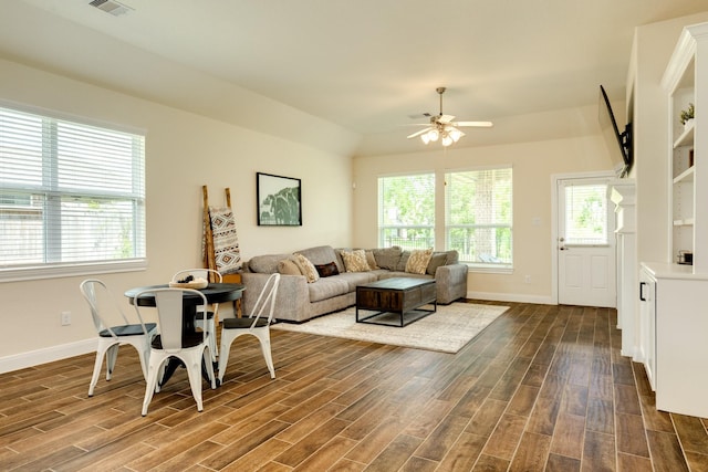 living room with dark hardwood / wood-style floors and ceiling fan