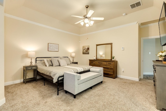 carpeted bedroom with a raised ceiling, ceiling fan, and crown molding