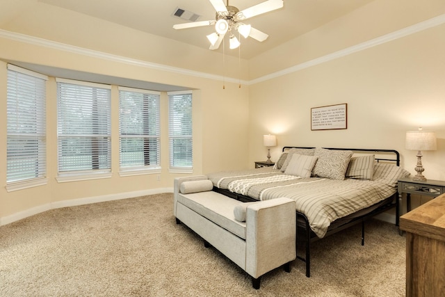 bedroom with light colored carpet, ceiling fan, crown molding, and a tray ceiling