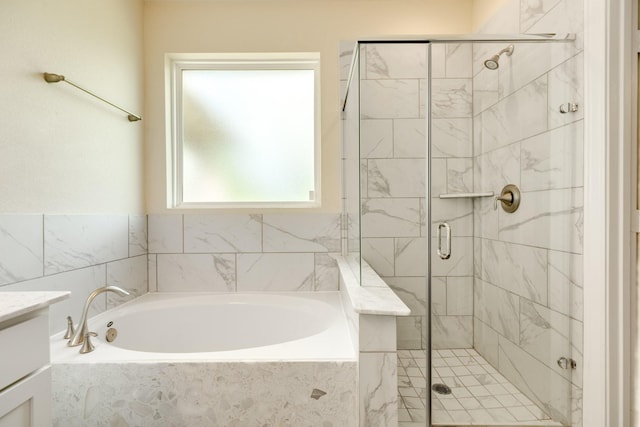 bathroom featuring plus walk in shower and vanity