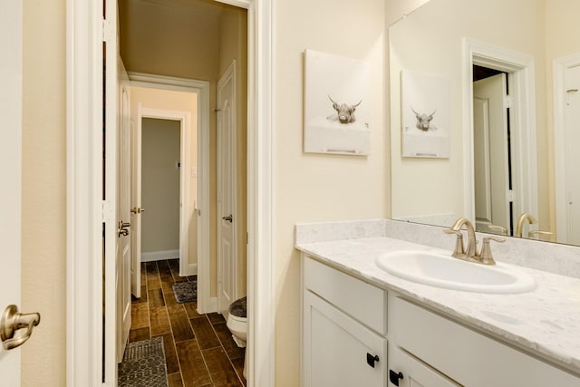 bathroom featuring hardwood / wood-style floors, vanity, and toilet