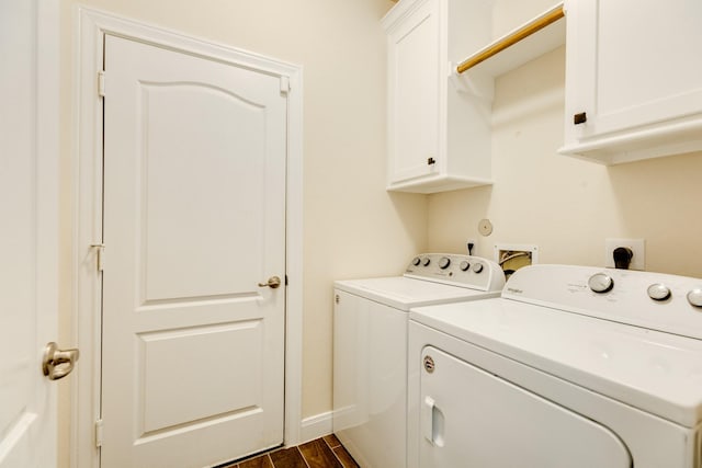 washroom with dark hardwood / wood-style floors, cabinets, and separate washer and dryer