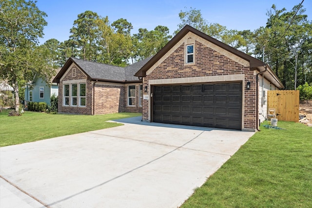 view of front of property featuring a front lawn and a garage