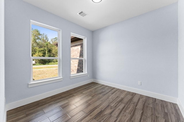 spare room with dark hardwood / wood-style flooring