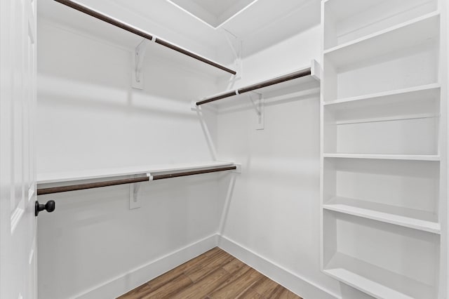 walk in closet with hardwood / wood-style floors