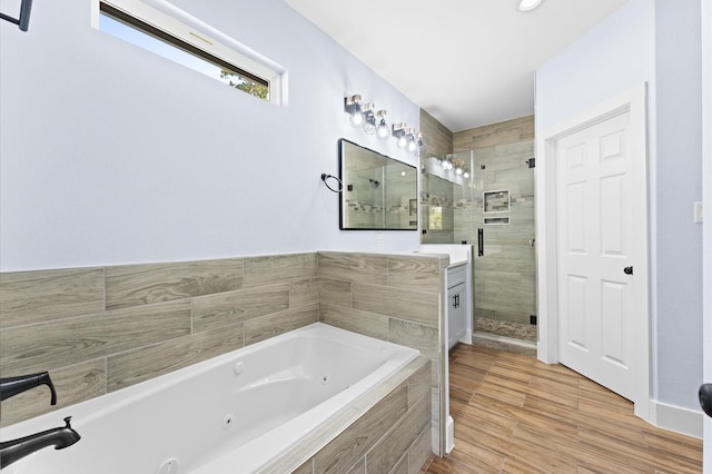 bathroom featuring hardwood / wood-style floors and independent shower and bath