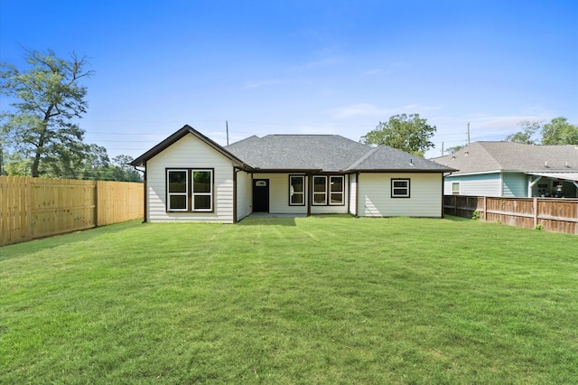 rear view of house with a yard