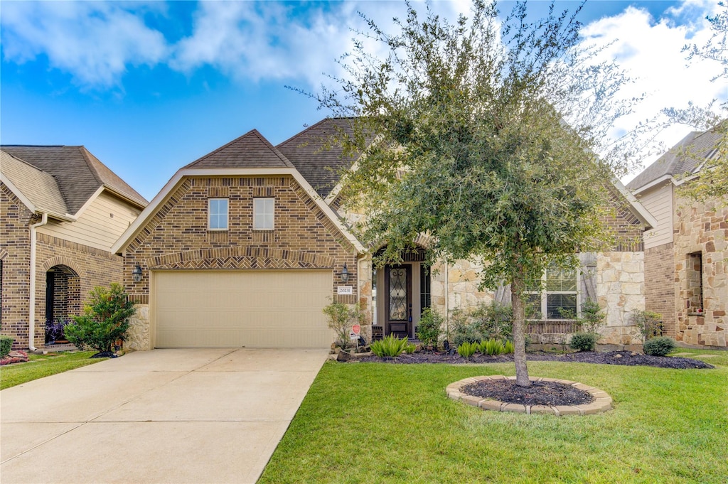 view of front of house with a garage and a front lawn