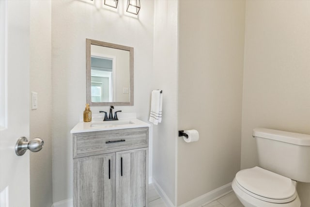 bathroom featuring tile patterned floors, vanity, and toilet