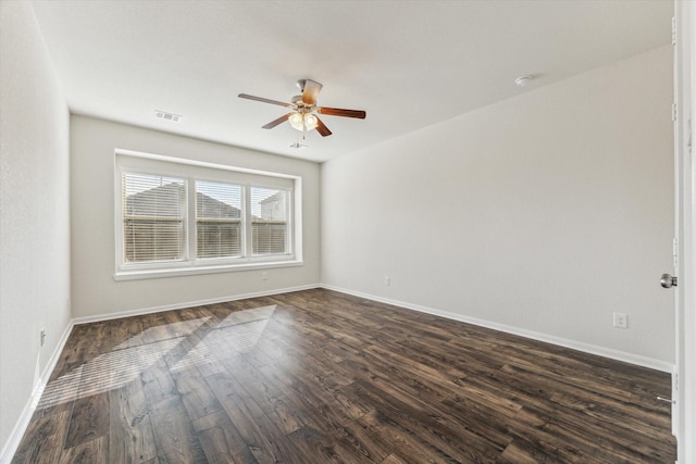 unfurnished room with ceiling fan and dark wood-type flooring