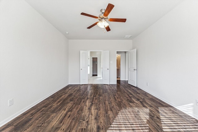 empty room featuring ceiling fan and dark hardwood / wood-style flooring