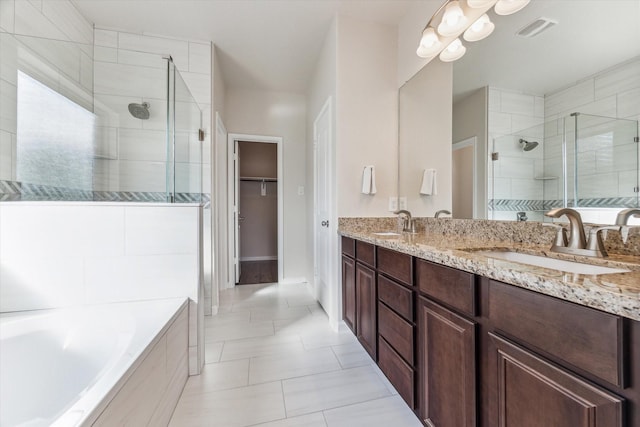 bathroom with tile patterned floors, vanity, and separate shower and tub