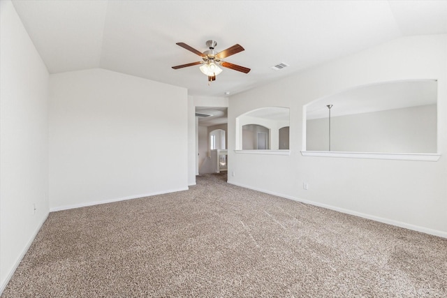 carpeted spare room featuring ceiling fan and lofted ceiling