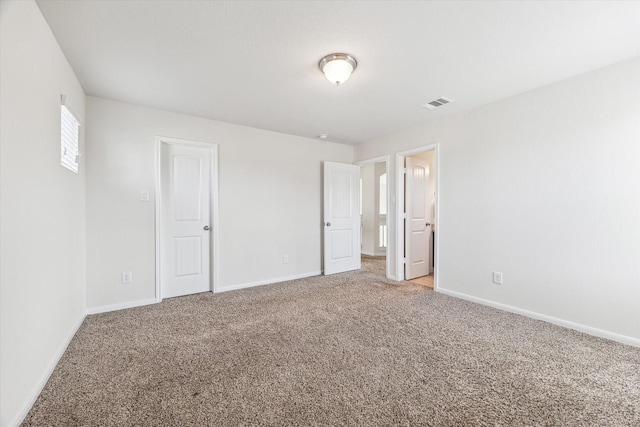 unfurnished bedroom featuring light carpet