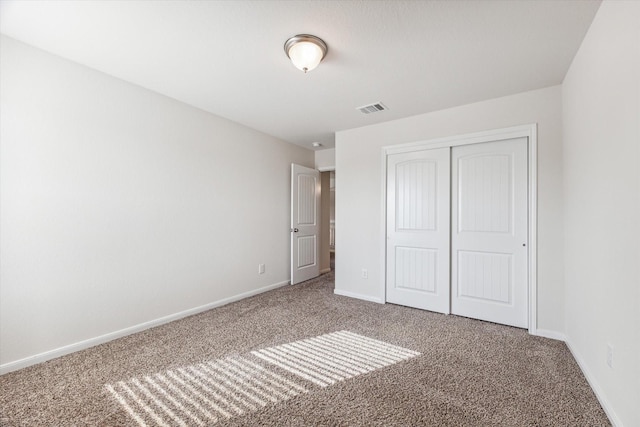 unfurnished bedroom with carpet and a closet