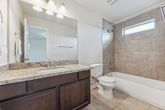 full bathroom featuring tile patterned floors, vanity, toilet, and tiled shower / bath