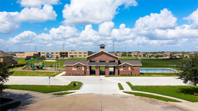 exterior space featuring a playground and a pool