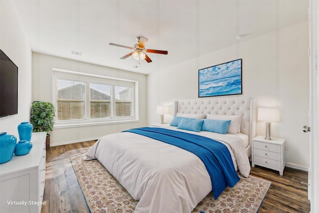 bedroom with ceiling fan and dark hardwood / wood-style flooring