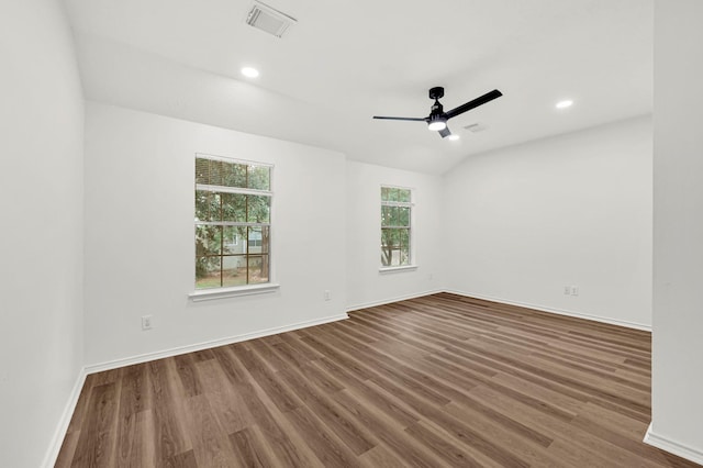 empty room featuring hardwood / wood-style floors, vaulted ceiling, and ceiling fan