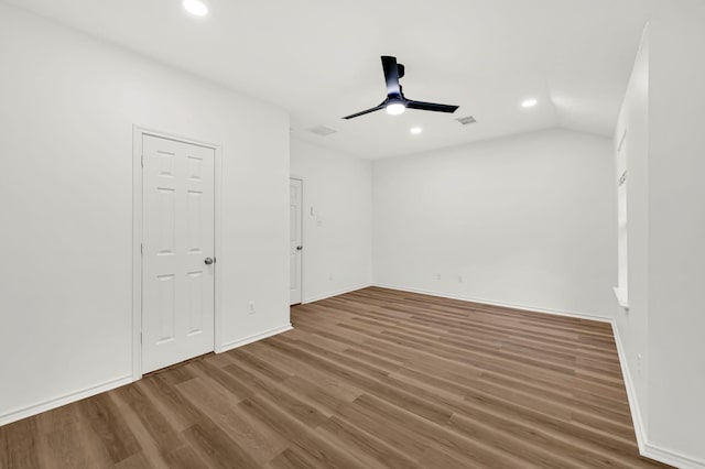 unfurnished room featuring ceiling fan, hardwood / wood-style floors, and lofted ceiling