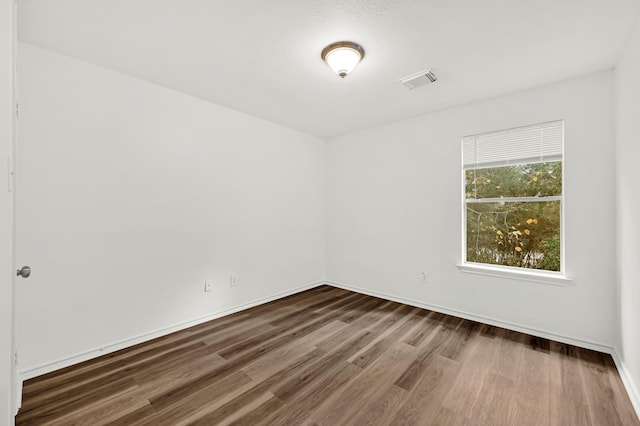 empty room with dark hardwood / wood-style floors