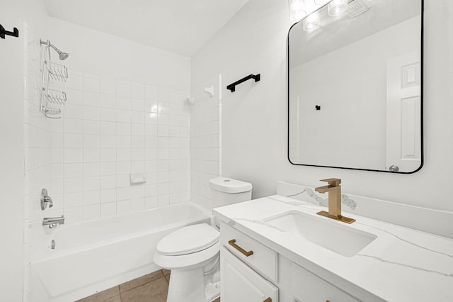 full bathroom featuring tile patterned flooring, toilet, vanity, and tiled shower / bath