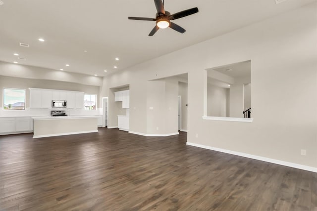 unfurnished living room featuring dark hardwood / wood-style floors and ceiling fan