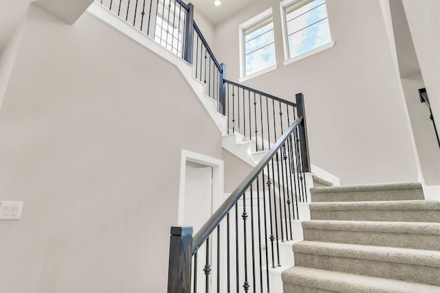 stairway featuring a high ceiling