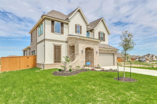 view of front of house featuring a front yard and a garage