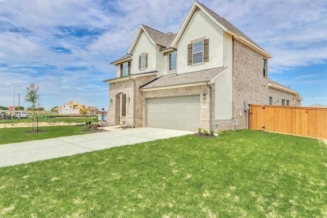 view of front of property featuring a front yard and a garage