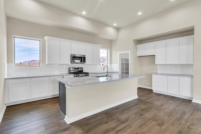 kitchen with white cabinetry, sink, an island with sink, and appliances with stainless steel finishes