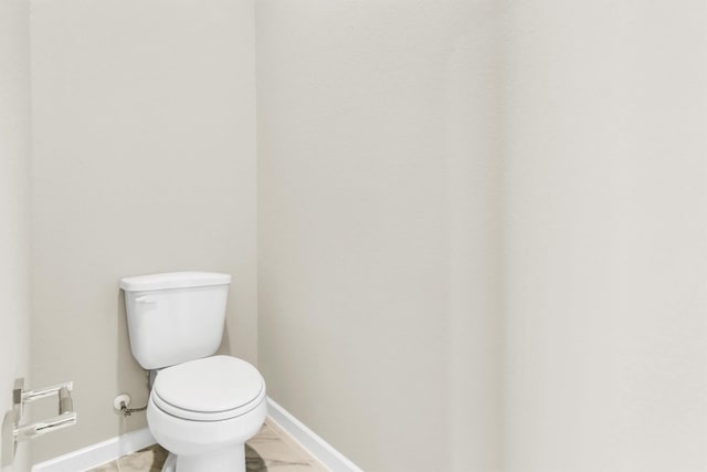 bathroom with tile patterned flooring and toilet