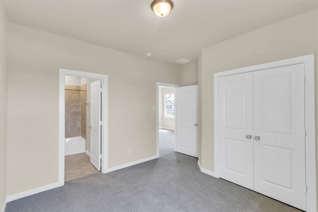 unfurnished bedroom with ensuite bath and a closet