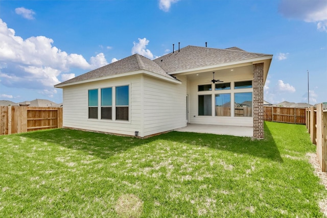 rear view of property with a yard, a patio, and ceiling fan