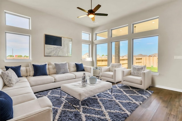 living room with ceiling fan and dark wood-type flooring