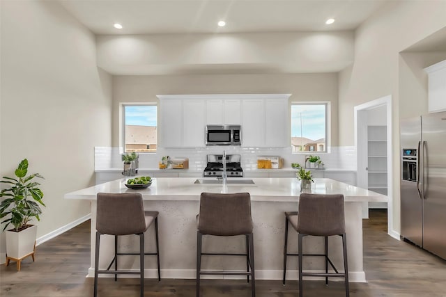 kitchen with plenty of natural light, an island with sink, and appliances with stainless steel finishes