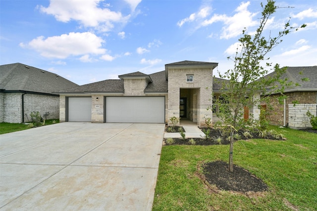 view of front of home with a front lawn and a garage