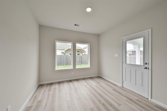 entrance foyer featuring plenty of natural light and light hardwood / wood-style floors