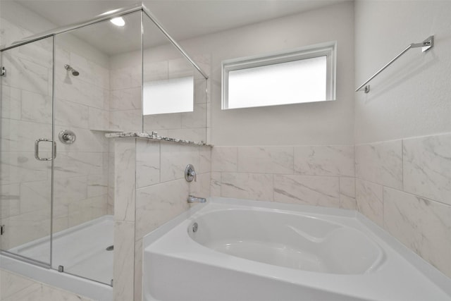 bathroom with separate shower and tub