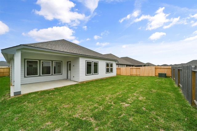 rear view of property with a patio and a lawn